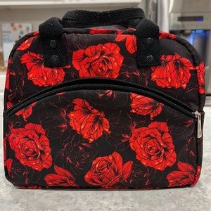 Black lunch-bag with red rose floral design with adjustable carrying strap